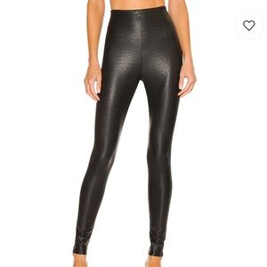 black faux leather animal-printed leggings.